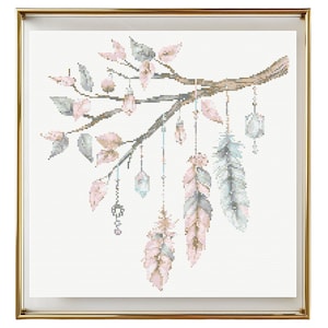 May include: A cross-stitch pattern featuring a delicate branch with pink and green leaves, adorned with hanging feathers and crystals. The feathers are in shades of pink, blue, and gray, and the crystals are clear and sparkly.