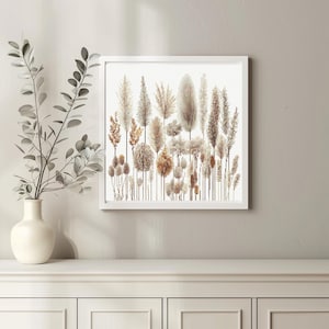 Può includere: Una stampa incorniciata bianca con uno sfondo beige che presenta una collezione di erbe e piante secche in varie tonalità di marrone e beige.