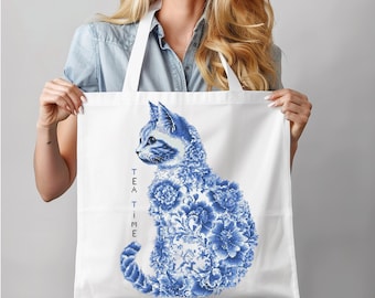 May include: White tote bag with blue and white floral design of a cat. The text "TEA TIME" is printed vertically on the left side of the bag.