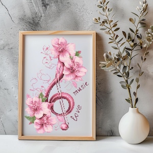 May include: A cross-stitch embroidery design featuring a pink musical note surrounded by pink cherry blossoms. The words "music" and "love" are stitched in pink below the note.