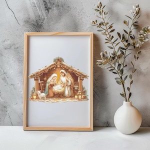 Puede incluir: Una impresión enmarcada que representa la escena de la Natividad. La obra de arte muestra a María, José y el niño Jesús en un establo, con un cordero pequeño y linternas. El marco es de madera clara.