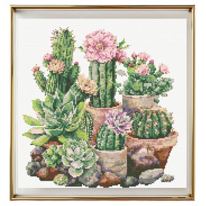 May include: A framed cross-stitch embroidery featuring a collection of cacti and succulents in various shades of green, pink, and brown. The cacti are potted in terracotta pots with a white background.