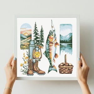 May include: A framed cross-stitch embroidery featuring a nature scene with a large fish, a pair of brown hiking boots, a thermos, a lantern, a basket of mushrooms, two pine trees, and two vertical landscape panels depicting mountains and a sunset.