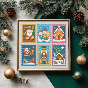 May include: Framed cross-stitch artwork with six Christmas-themed postage stamp designs. The stamps show Santa Claus, snowmen, a gingerbread house, Santa in a sleigh, a nutcracker, and a cabin under the Northern Lights. The frame is a light brown colour.