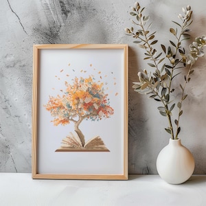 Può includere: Una stampa incorniciata di un libro con un albero che cresce da esso. L'albero ha foglie arancioni, gialle e marroni. Il libro è aperto e le pagine sono aperte. La stampa è su uno sfondo bianco ed è incorniciata in una cornice di legno chiaro.
