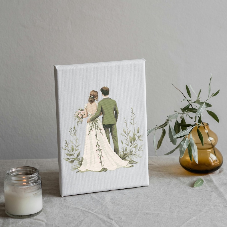 May include: A white canvas painting of a bride and groom in a forest setting. The bride is wearing a white dress and the groom is wearing a green suit. They are both looking away from the viewer.