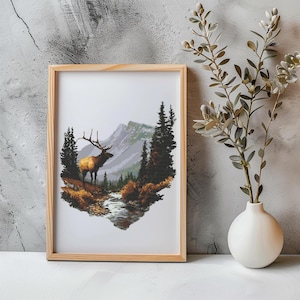 May include: A framed print of a brown and tan elk standing in a forest with a stream running through it. The elk is looking to the left of the image. The background is a mountain range with trees and a blue sky.