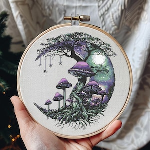 May include: A cross-stitch embroidery in a wooden hoop features a fantasy scene with purple mushrooms, a tree, and a moon. The design includes hanging spiders and a detailed, colorful landscape.