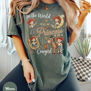 Toy Story Jessie And Bullseye Shirt, In a World Full of Princesses Be a Cowgirl Tee, Pixar Movie Fan Gift, Disney Western Cowgirl Outfits Moss/Military Green