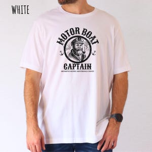 May include: White t-shirt with a black and white illustration of a captain with a beard and a pipe. The illustration is inside a circle with the text "Motor Boat Captain" and the text "Uncharted Waters, Questionable Choices" below the circle.