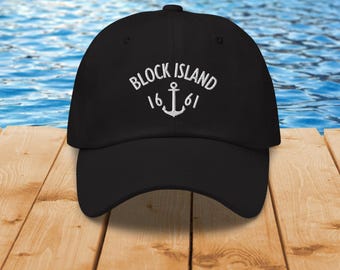 May include: Black baseball cap with white embroidered text that reads "Block Island 1661" with an anchor symbol.