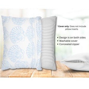 May include: Decorative pillow covers with a coastal theme. One cover features a white background with blue seashell patterns. Another has gray and white stripes. The text on the image says: "Cover only: Does not include pillow inserts. Design is on both sides. Washable cover. Concealed zipper."