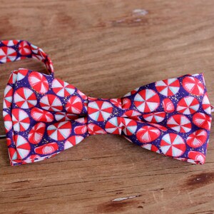 Fun holiday bow tie for kids, peppermint candies on blue background with gold flecks, teen child youth kid toddler infant bowtie, Christmas