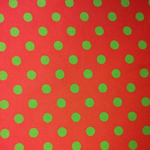 May include: Red fabric with a repeating pattern of green polka dots.