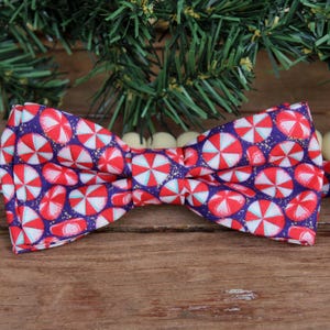 Fun holiday bow tie for kids, peppermint candies on blue background with gold flecks, teen child youth kid toddler infant bowtie, Christmas
