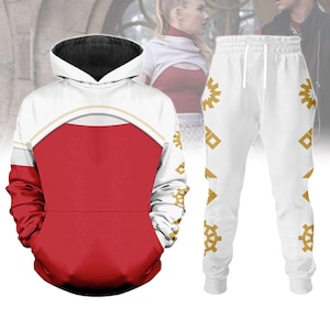 May include: A white and red hoodie with a black hood and a matching pair of white sweatpants. The hoodie has a red front panel and white sleeves. The sweatpants feature gold geometric designs.