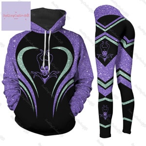 May include: A purple and black hoodie and leggings set with a glitter pattern. The hoodie has a heart-shaped design with a silhouette of Maleficent from Disney's Sleeping Beauty. The leggings have a chevron pattern with a silhouette of Maleficent on the leg.