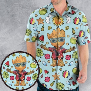 May include: Light blue short-sleeved shirt with a repeating pattern of beach-themed icons and a cartoon character wearing sunglasses. The shirt has a button-down collar and a small, circular graphic of the same design.