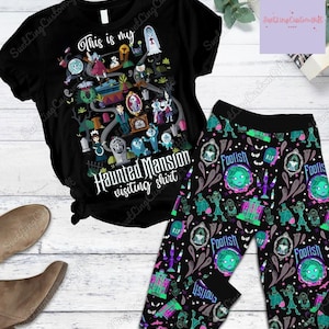 Könnte beinhalten: Schwarzes T-Shirt und Leggings-Set mit Haunted Mansion-Motiv. Das Shirt hat eine farbenfrohe Grafik mit dem Text "This is my Haunted Mansion visiting shirt." Die Leggings haben ein sich wiederholendes Muster aus Geistern und anderen gruseligen Elementen.