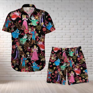 May include: A black and white patterned button-up shirt and matching shorts featuring characters from a classic fairy tale. The pattern includes flowers, leaves, and characters such as a prince, princess, and a fairy.