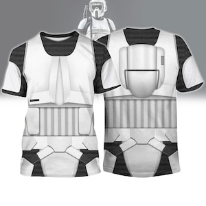May include: White and black t-shirt featuring a detailed design resembling a Star Wars Scout Trooper's armor. The front and back of the shirt are visible, showcasing the helmet and armor details. The shirt has a crew neck and short sleeves.