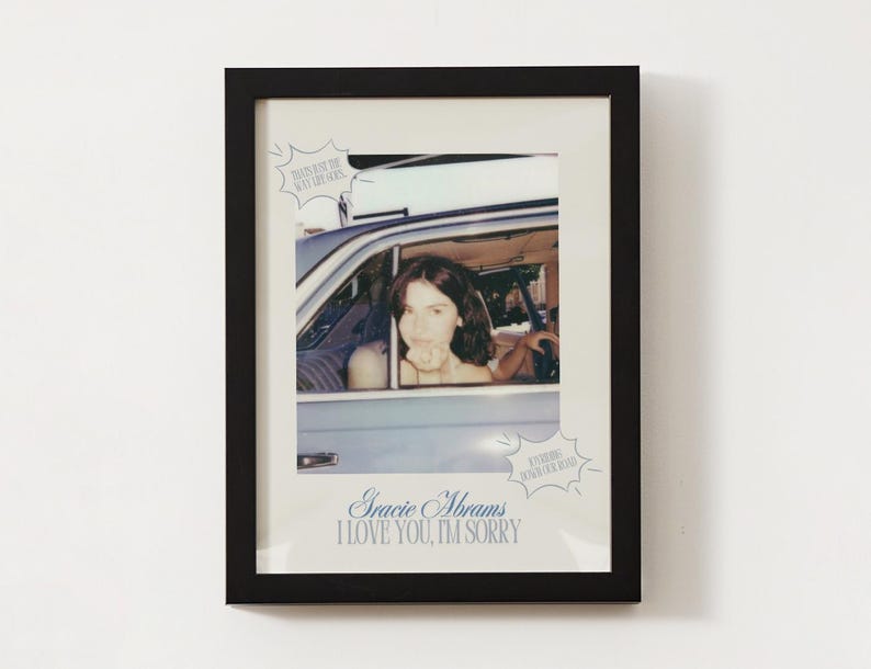 May include: A framed photo of a woman in a car with the text "Gracie Abrams I love you, I'm sorry" and "Everything Could Be Different" in a speech bubble.