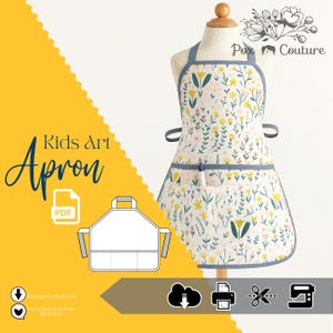 Peut inclure: Un tablier d'art pour enfants blanc avec un motif floral de fleurs jaunes et roses, souligné de gris. Le tablier a une bordure grise et une poche avec un stylo. Les mots "Kids Art Apron" sont affichés en bleu.