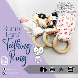 May include: Three wooden teething rings with fabric bunny ears. The ears feature floral, owl, and Halloween-themed patterns in white, orange, and black. The text "Bunny Ears Teething Ring" is displayed in a cursive font.