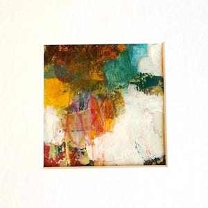 May include: Abstract mixed media artwork with a vibrant colour palette. The piece features layers of paint in shades of yellow, teal, orange, and white, creating a textured and dynamic composition. The artwork is presented in a white mount.