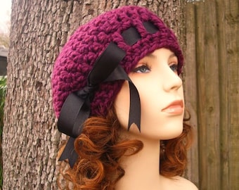 May include: A crochet pattern for a burgundy beret with a black ribbon bow. This listing is a DIY tutorial to make your own beret, not the finished item.