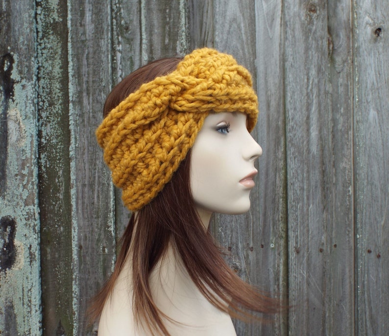A chunky knit crochet twisted headband.  This head band comes in 33 colors, shown here in mustard. This headband fits an average adult and teen head size of 20 to 23 inches.