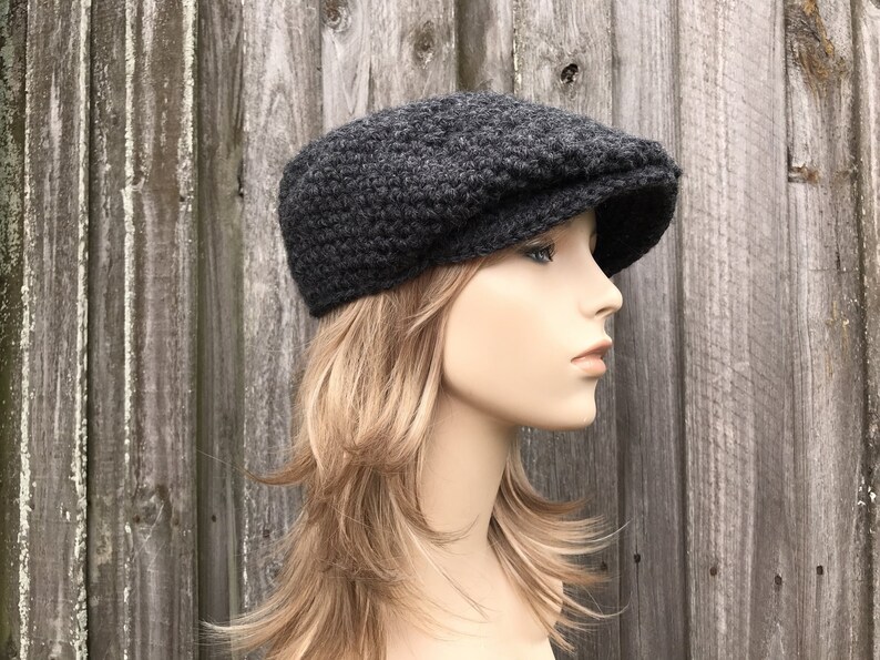 A chunky crochet golf cap in a charcoal grey color. It fits an average adult and teen head of 20 to 23 inches.