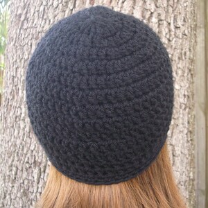 May include: A black crocheted beanie hat.