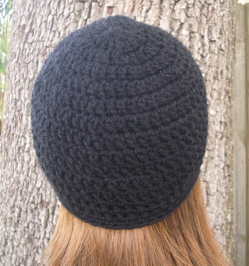 May include: A black crocheted beanie hat.