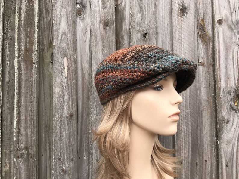 A multi color chunky crochet golf cap. This hat fits an average adult and teen head size of 20 to 23 inches.