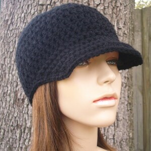 A fitted light weight crochet beanie with attached brim visor in black. This hat fits an average adult and teen head size of 20 to 23 inches.