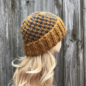 May include: A knitted beanie hat with a brown and blue checkered pattern. The hat is made of a soft, warm yarn and is perfect for keeping your head warm in the winter.