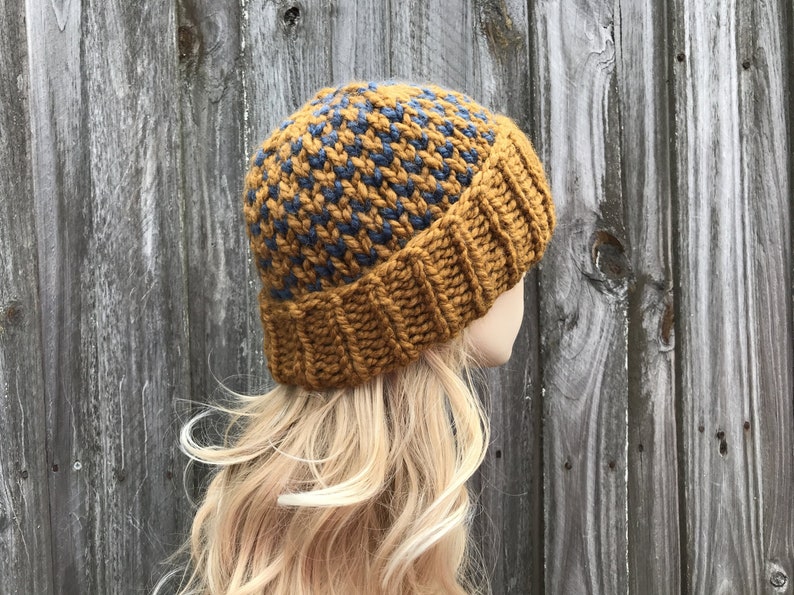 May include: A knitted beanie hat with a brown and blue checkered pattern. The hat is made of a soft, warm yarn and is perfect for keeping your head warm in the winter.