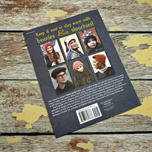 May include: Book cover with the title "Keep it cool or stay warm with beanies & slouchies!"  The cover features photos of people wearing various knitted hats. The text on the back of the book describes the book as a collection of original designs for men and women.