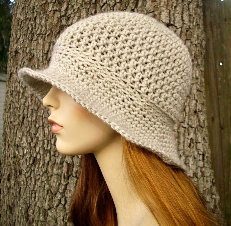 A crochet sun hat in a soft beige. This hat fits an average adult and teen head size of 20 to 23 inches.