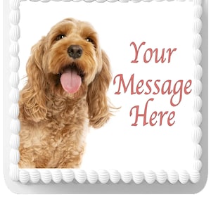 May include: A rectangular cake with a white frosting border and a light brown dog image. The dog has long, curly fur and its tongue is sticking out. The text "Your Message Here" is in pink script.
