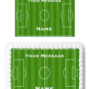 May include: A green and white personalised cake topper featuring a football pitch with the text "YOUR MESSAGE" and "NAME".
