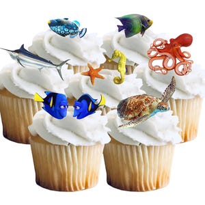 May include: Cupcakes with white frosting and various sea creature decorations, including a blue tang fish, a seahorse, an octopus, and a sea turtle. The cupcakes have a light brown base.