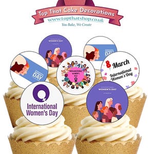May include: Cupcakes with white frosting and gold cupcake liners, topped with International Women's Day themed edible toppers. The toppers feature illustrations of women and text that reads "International Women's Day".