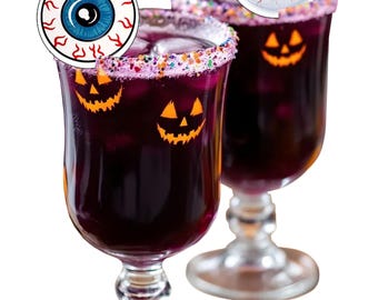 May include: Two stemmed glasses filled with a dark purple beverage, garnished with colorful sprinkles and a decorative eyeball. Each glass features a jack-o'-lantern face. A festive Halloween cocktail.