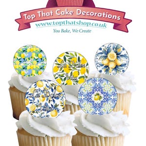 May include: Cupcakes with white frosting and edible toppers featuring lemon designs and the text "La Dolce Vita." The toppers have various patterns, including lemons and floral arrangements. The image also displays the text "Top That Cake Decorations."