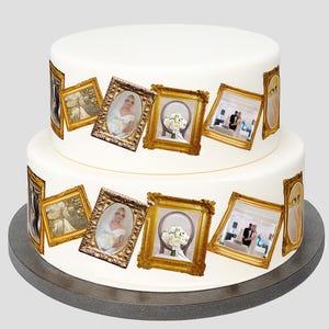 May include: Two-tiered white wedding cake decorated with edible framed photos. The gold frames contain images of a bride, a bouquet, and a couple. The cake sits on a grey cake stand.