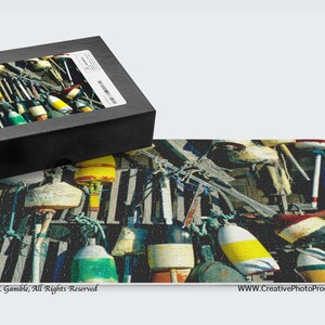 May include: A colorful jigsaw puzzle featuring a close-up of a wall covered in a variety of colorful buoys. The buoys are mostly red, yellow, and green, and they are arranged in a random pattern. The buoys are hanging from a wooden wall, and there are some ropes and other nautical items in the background.