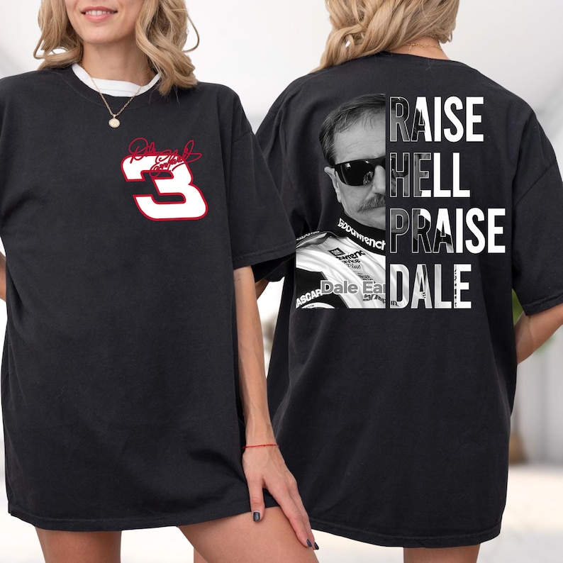 May include: Black t-shirt featuring a white and red number 3 with a signature on the front. The back of the shirt displays a black and white image of a man with sunglasses and the words "RAISE HELL PRAISE DALE".
