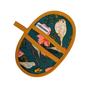 May include: An oval-shaped oven mitt with a teal background featuring a floral and bird design. The mitt has a mustard yellow trim and a matching loop for hanging. The brand name "collisionware" is printed on the mitt.
